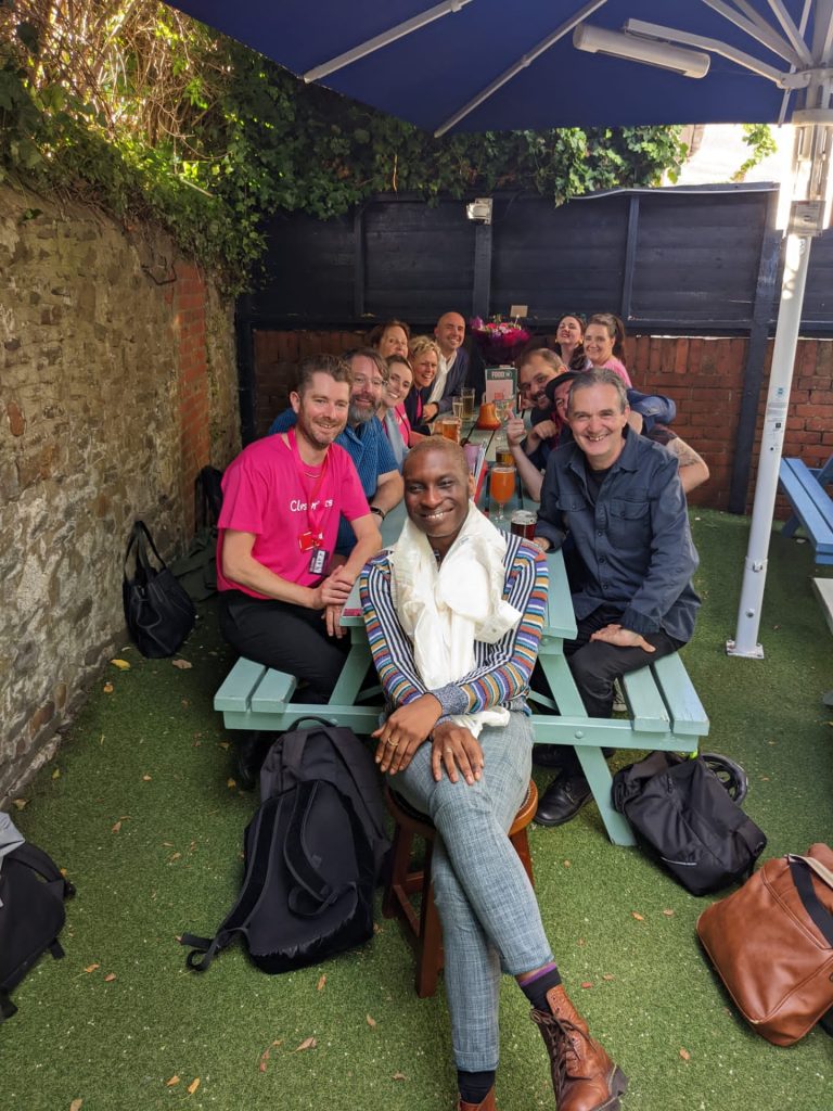 Laolu and colleagues having drinks in a beer garden together after the ClwstwrVerse event.