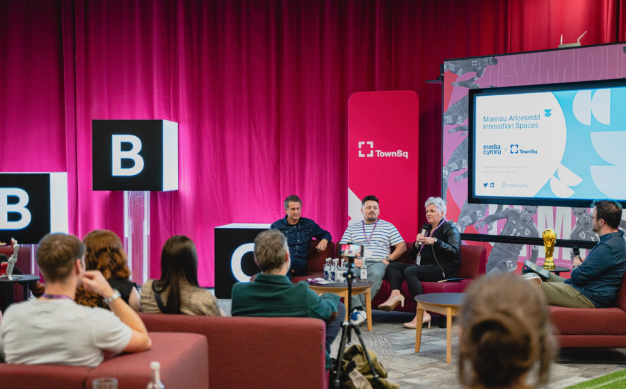 Four people giving a presentation to an audience at the BBC