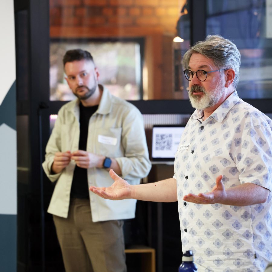 Man standing up at an event talking to an audience