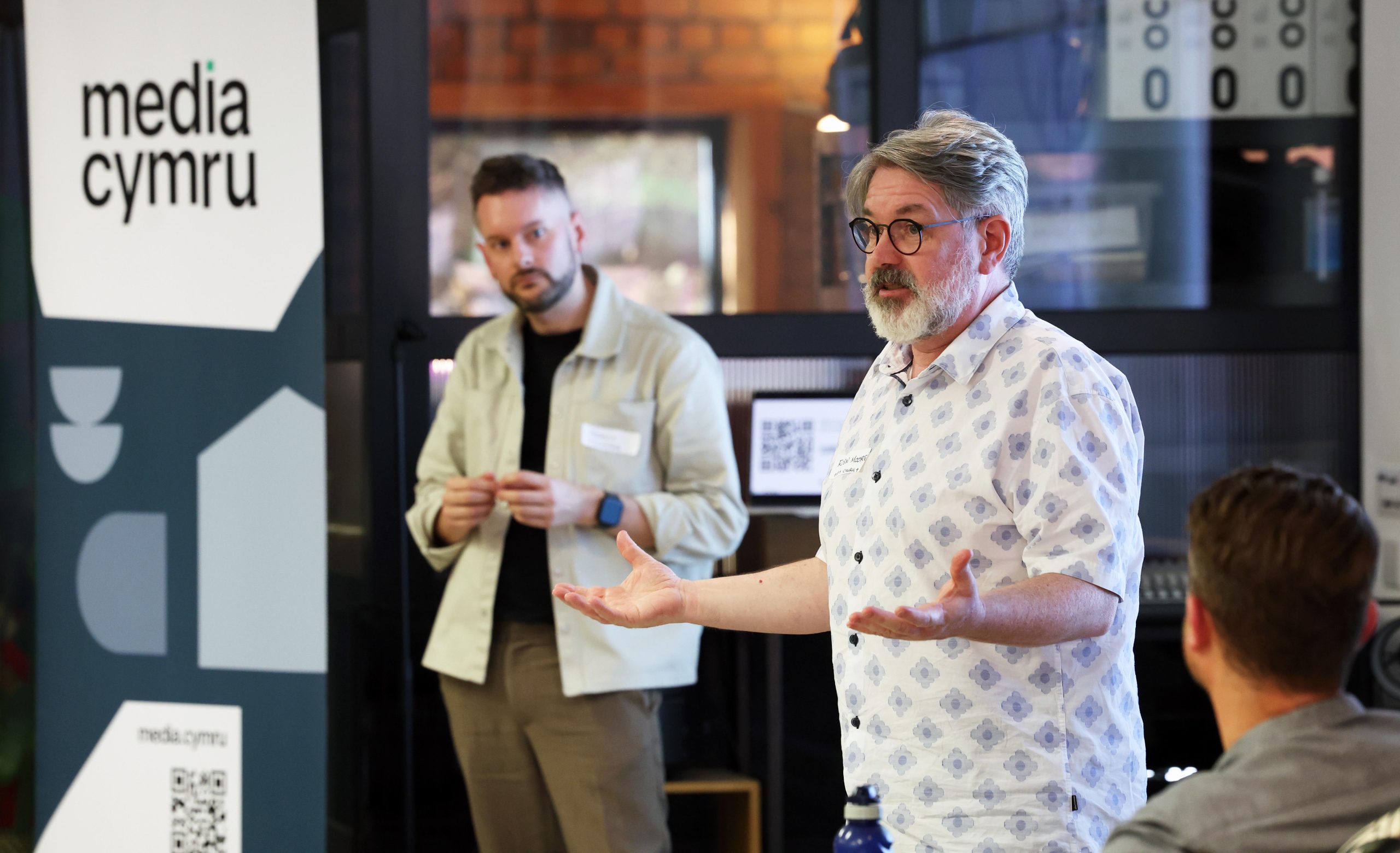 Man standing up at an event talking to an audience