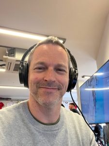 man wearing headphones and smiling