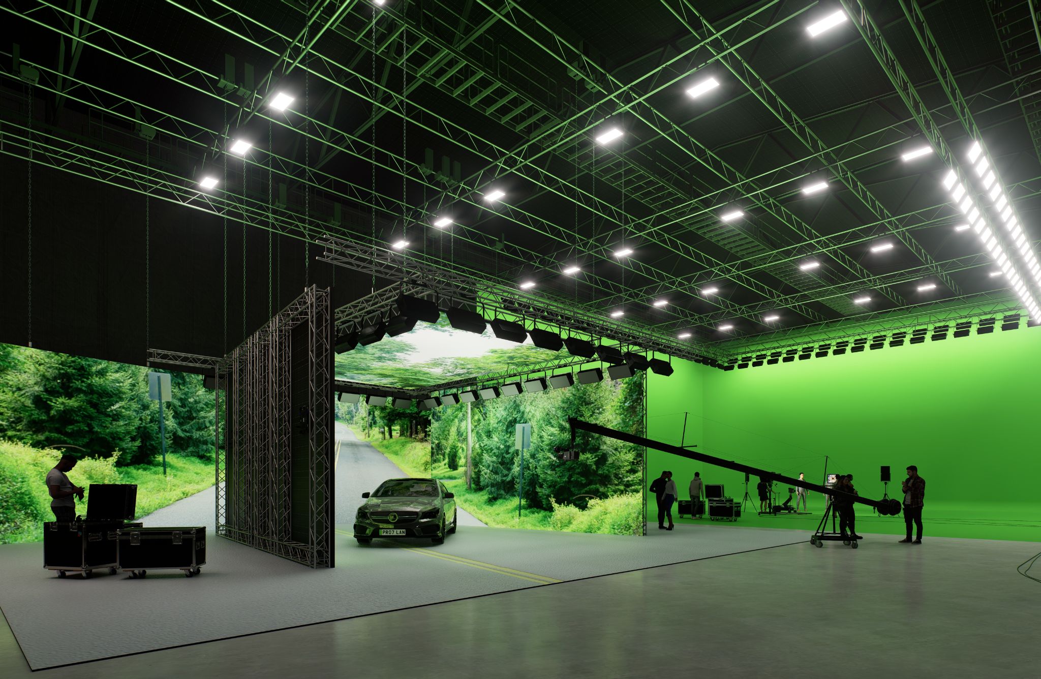 studios with a large green screen, there is a lighting rig on the ceiling and a car, TV crew and people in the green screen