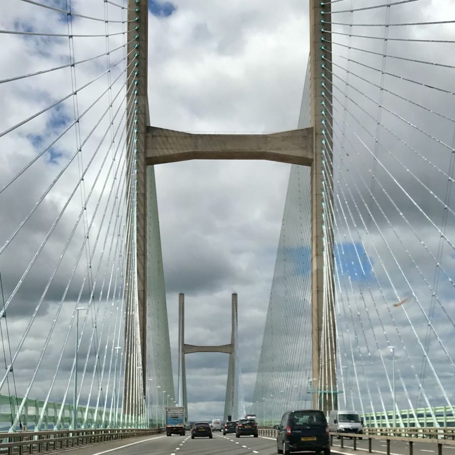 View of the Severn bridge midway across it by car, looking up at the suspension cables.