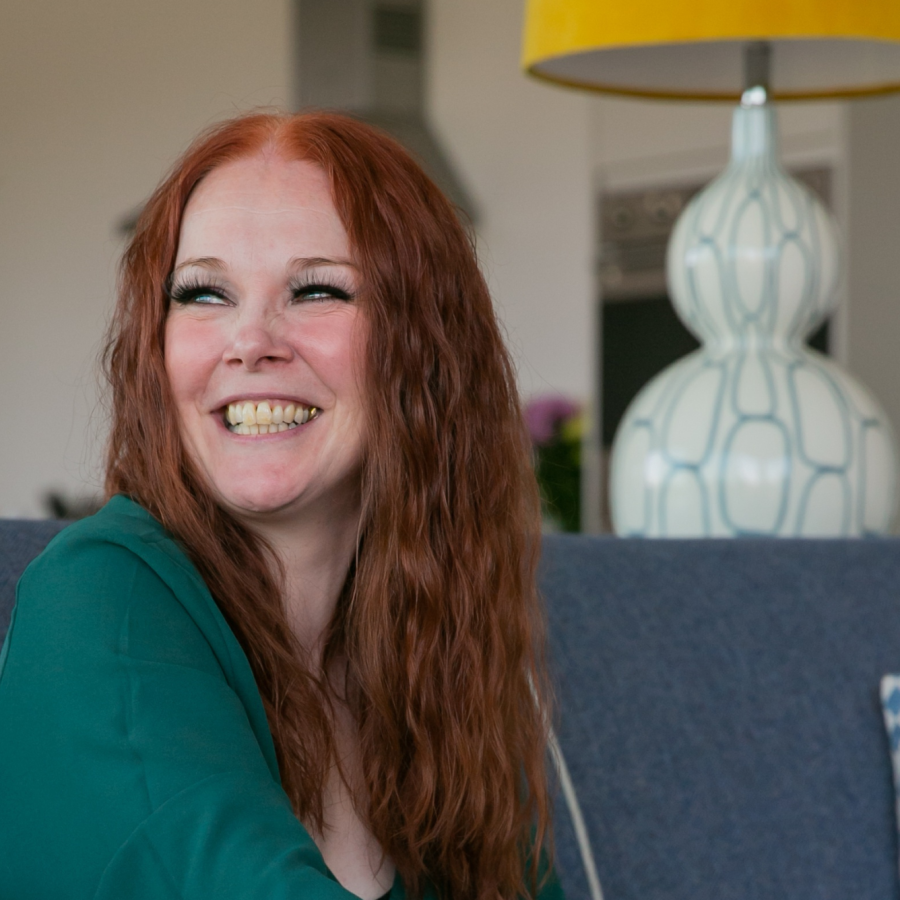 Woman sitting on a sofa smiling