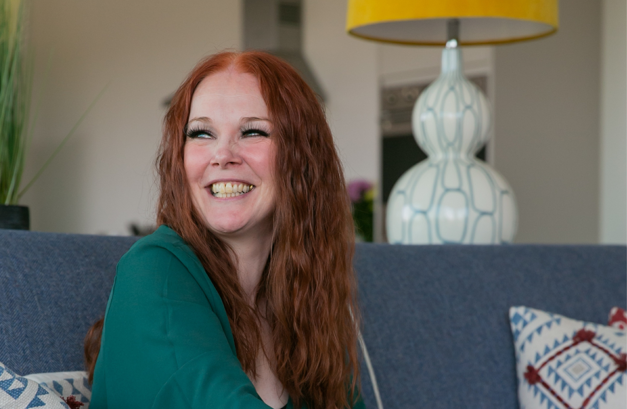 Woman sitting on a sofa smiling
