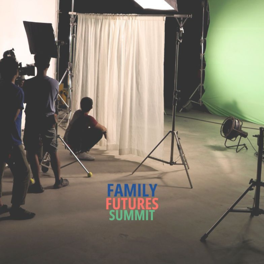 A behind-the-scenes view of a film or photo shoot set. Several crew members are working with cameras and lighting equipment. A person is sitting on the floor near a white curtain backdrop, with a green screen in the background. The text 'FAMILY FUTURES SUMMIT' appears at the bottom centre in blue, red, and green.